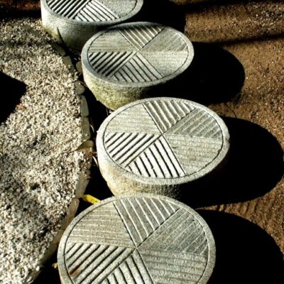 Round granite paver with geometrical carved patterns