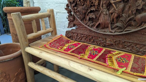 Wooden bench with colourful cloth on it